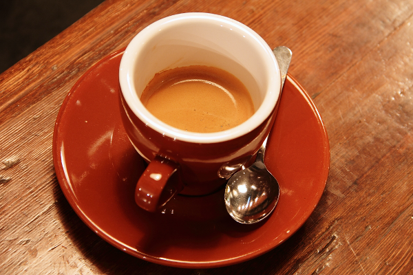 Coffee cup and saucer on a textured wooden table